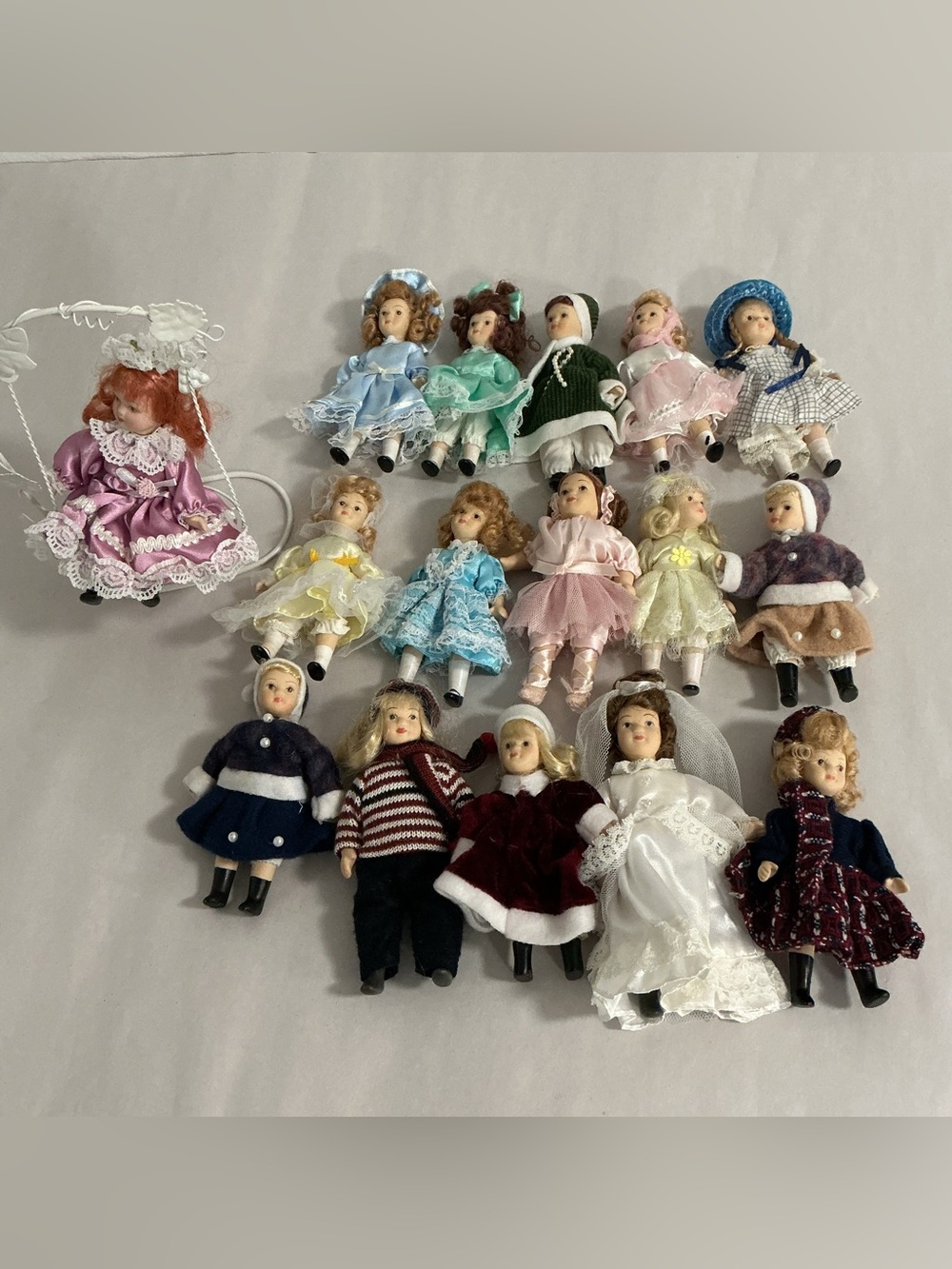 16 mini Moveable Porcelain  Dolls & Metal Swing